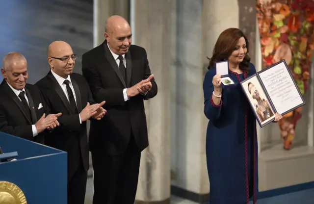 Winners of the 2015 Nobel Prize, Tunisian National Dialogue Quartet members, Secretary General of the Tunisian General Labour Union (UGTT) Houcine Abassi, President of the Tunisian Order of Lawyers Mohamed Fadhel Mahfoudh and President of the Tunisian Human Rights League Abdessattar Ben Moussa applaud as President of the Tunisian Confederation of Industry, Trade and Handicrafts Wided Bouchamaoui poses with her medal and certificate during the Nobel Peace Prize award ceremony in Oslo, Norway, December 10, 2015