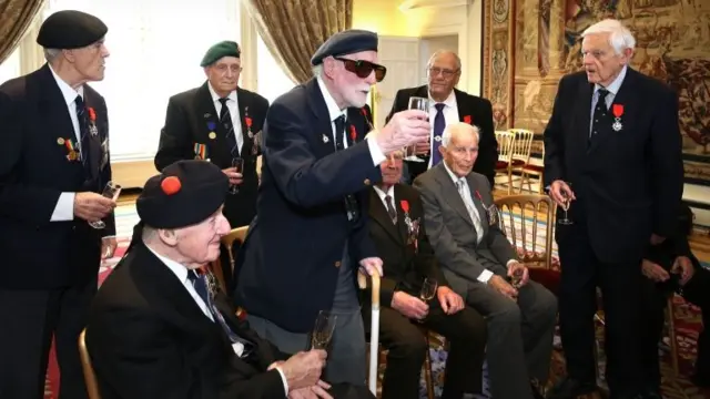 Albert Wright gives a toast with a glass after receiving the Legion d'Honneur