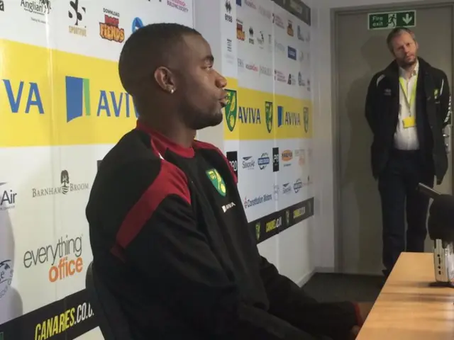 Sebastien Bassong, seated, at the press conference