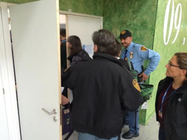 security guard at door of briefing room