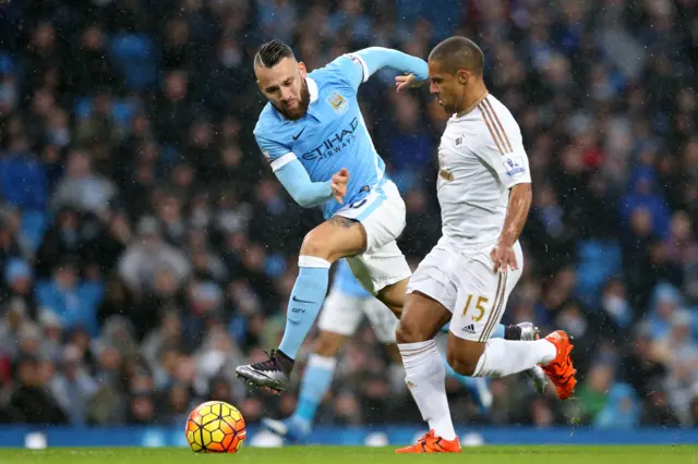 Wayne Routledge up against Nicolas Otamendi