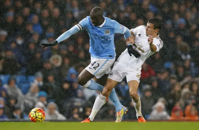 Yaya Toure battles for the ball
