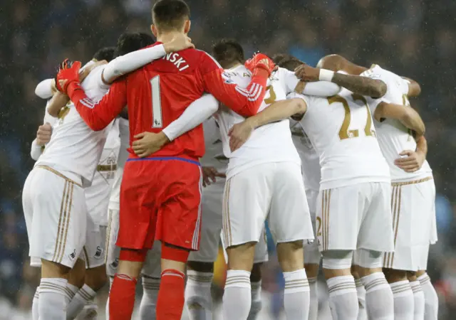 Swansea players huddle before kick off