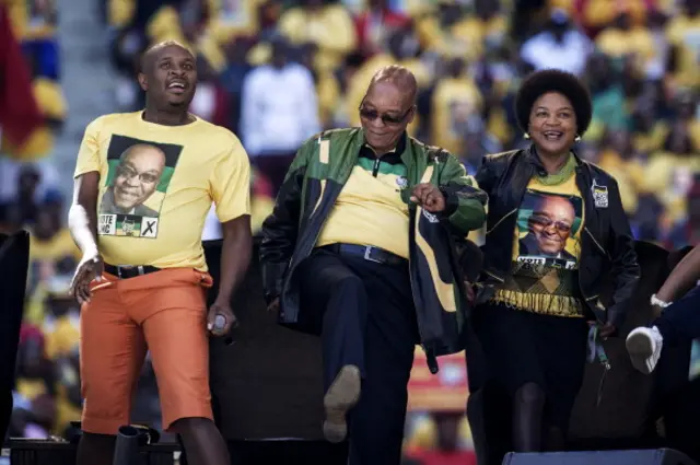 South African President and African National Congress president Jacob Zuma (C) dances ahead of his address during the final ANC election campaign rally at Soccer City stadium on May 4, 2014 in Johannesburg, South Africa