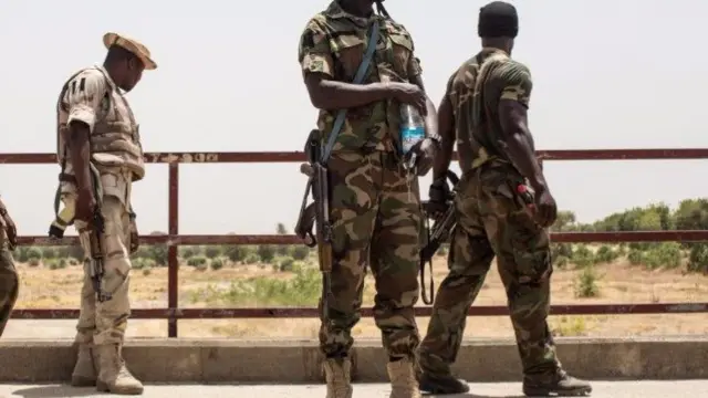 Nigerian troops stand on a bridge that was used by Boko Haram as an execution site in the outskirts of Bama on March 25, 2015.