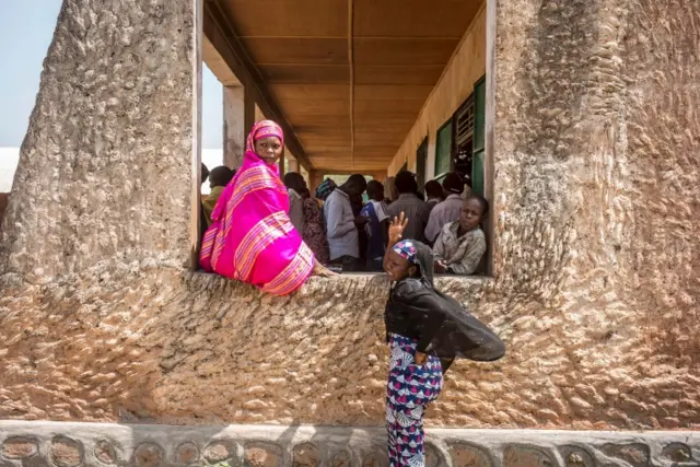 Voters queue at the polling station at the Koudoukou school in the flashpoint PK5 district in Bangui on December 14, 2015