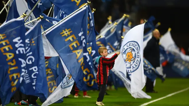 A young Leicester fan waves a flag