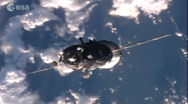 Soyuz with Earth and clouds below