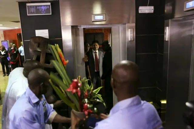 The first customer since an attack by gunmen in November, enters the elevator of the Radisson Blu hotel after it reopened in Bamako