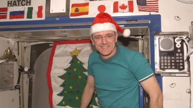 Astronaut wearing Christmas hat