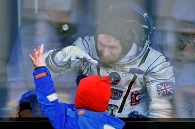 Tim Peake waves to his son