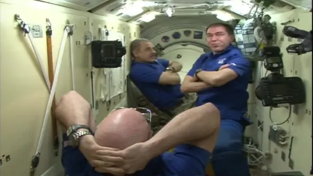 Astronauts with arms folded