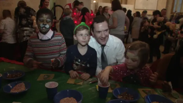 Chancellor George Osborne with children at the charity Christmas Party