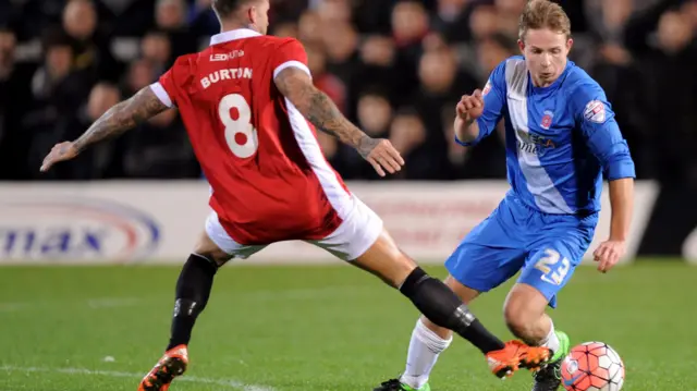 Scott Burton of Salford City fouls Connor Smith of Hartlepool United