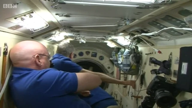 Astronauts with open hatch