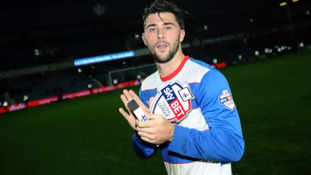 Charlie Austin celebrates with the Man of the Match award