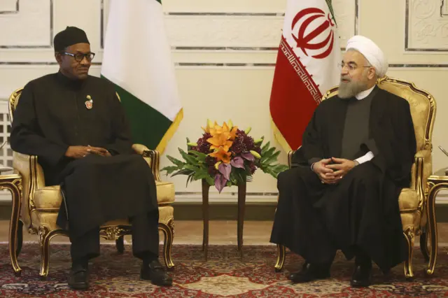 Iranian President Hassan Rouhani, right, talks with Nigerian President Muhammadu Buhari during their meeting in Tehran, Iran