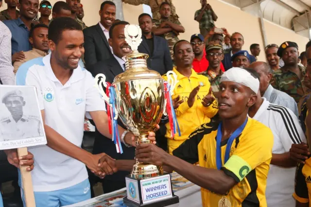 A Hoseed footballer being handed the gold cup