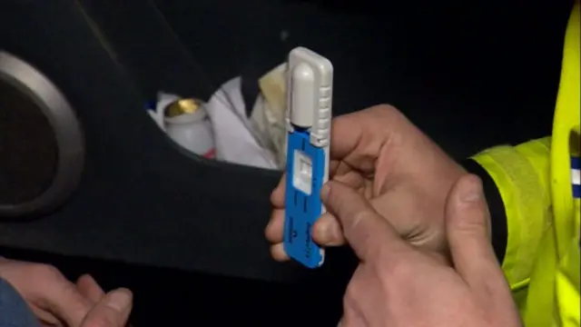 Police officer holding a drug testing kit