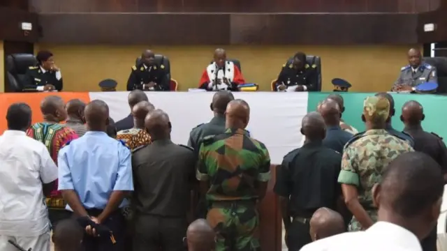 Suspected killers of former general and junta leader Robert Guei, assassinated in September 2002, stand before judges during their trial on 17 December 2015 in Abidjan