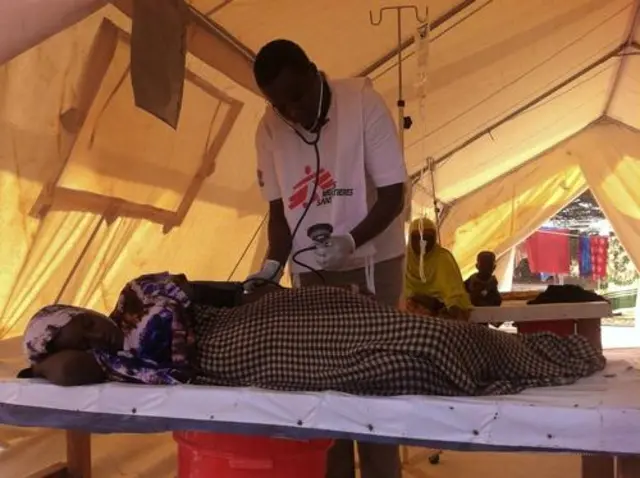 An MSF staff member attending to a patient in Dadaab