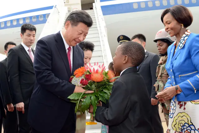 Chinese President Xi Jinping (L)is welcomed by South African minister for International Relations Maite Nkoana-Mashabane (R)as he arrives at the Waterkloof airfield in Pretoria on 2 December 2015.