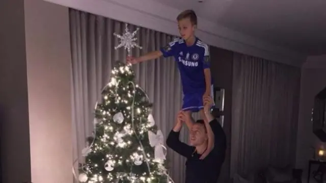 John Terry and son decorate a Christmas tree