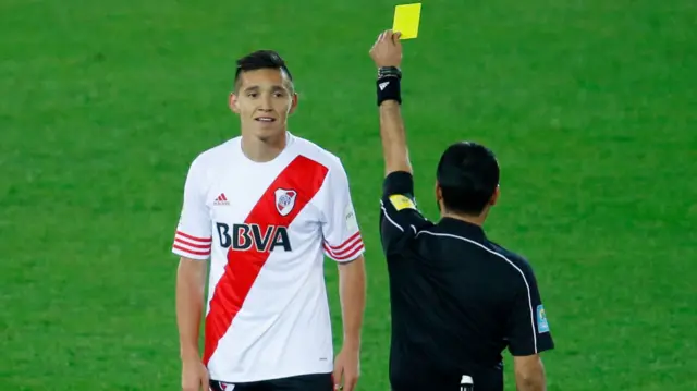 Matias Kranevitter is shown a yellow card