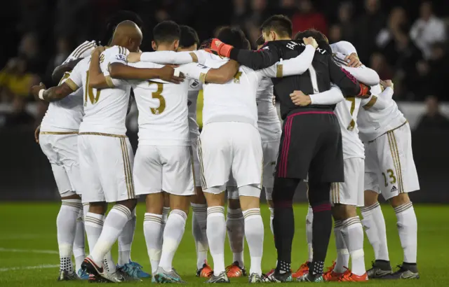 Swansea players stand in a huddle