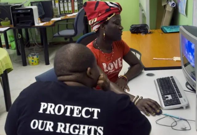 alawian Tiwonge Chimbalanga (R) shares on November 16, 2012 some of her experiences with Charlie Takati, outreach officer at the local charity Gender Dynamix, at their offices in Athlone, about 15 kms from the center of Cape Town