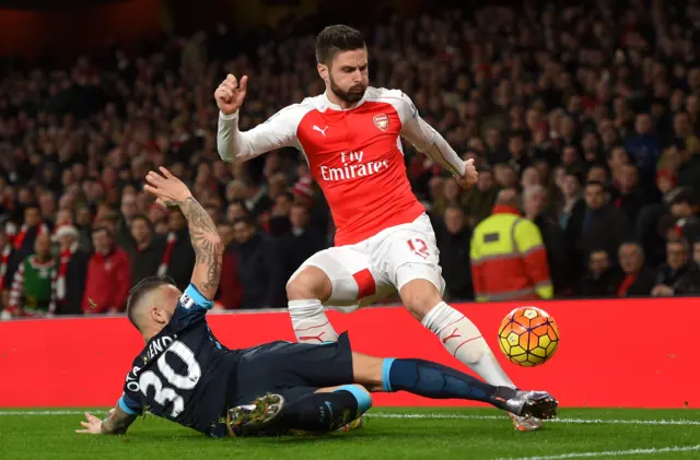 Arsenal striker Olivier Giroud is tackled by Nicolas Otamendi