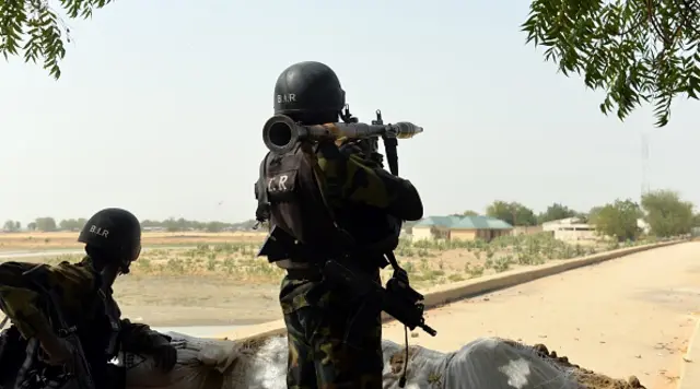 A picture taken on 17 February 2015 shows Cameroonian soldiers holding a position in the Cameroonian town of Fotokol, on the border with Nigeria