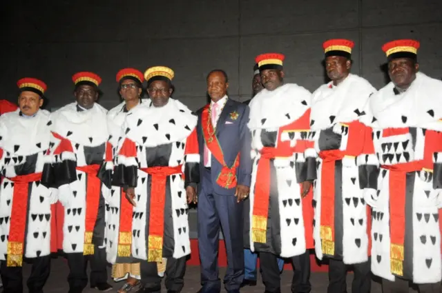 Guinea's president Alpha Conde (C) poses with members of Guinee's Constitutional Court after swearing the oath for the second term of his presidency on December 14, 2015 in Conakry