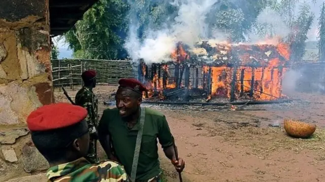 Security agents near a burning building in Burundi