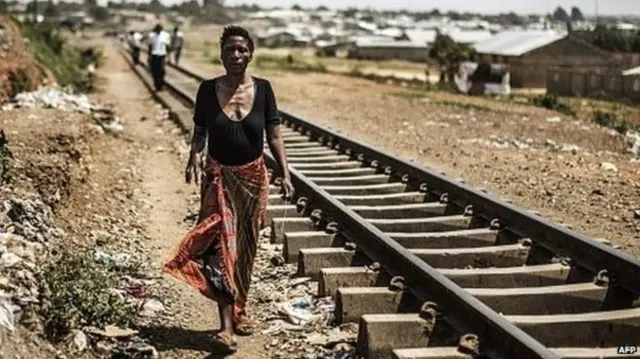 Woman walking by rail