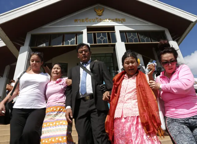 The mother of Zaw Lin (second right) cries as she leaves court