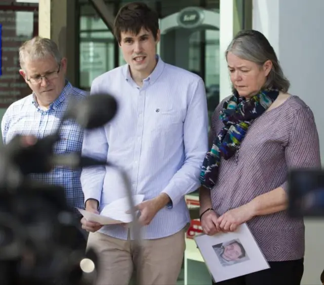 Michael Miller giving a statement flanked by his parents