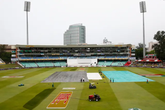 A general view as covers remain on the pitch