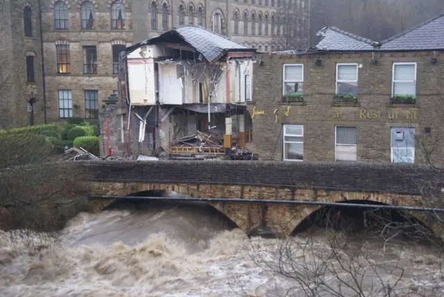 collapsed restaurant over rushing river