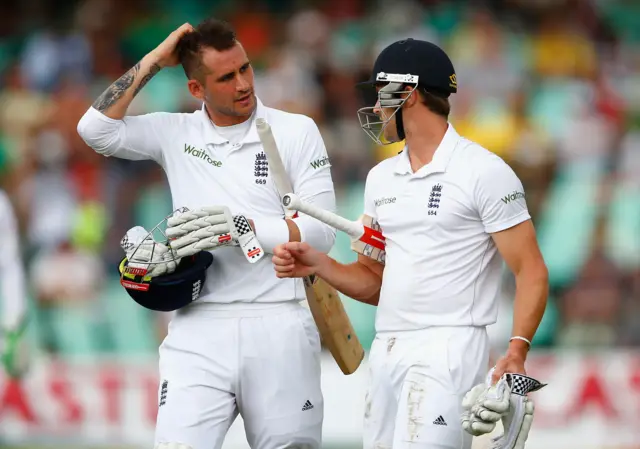 Alex Hales and Nick Compton of England walk off as rain returns