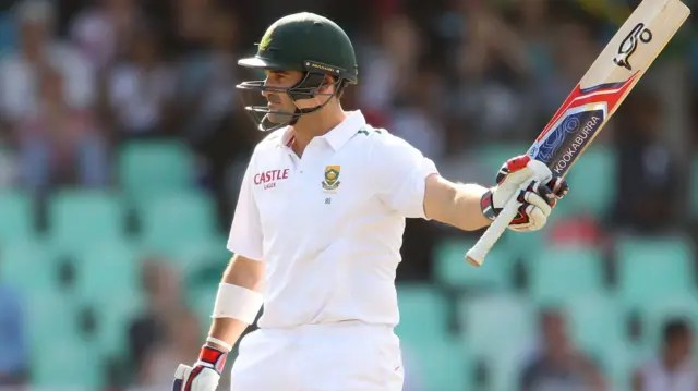 Dean Elgar raises his bat after making his 50