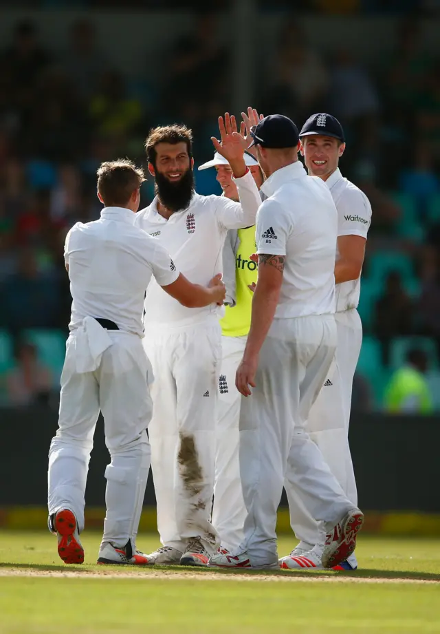 Moeen Ali of England is congratulated after taking the wicket of Faf du Plessis