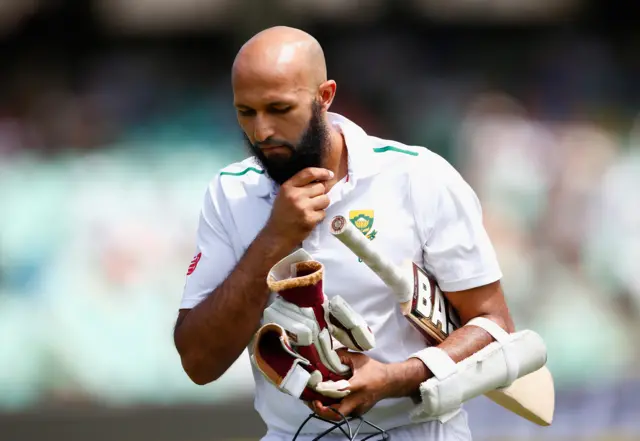 Hashim Amla of South Africa walks off