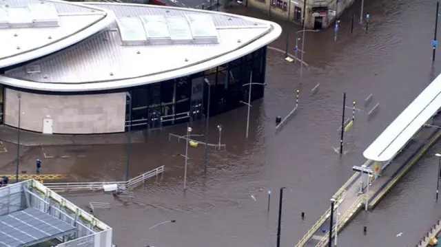 The River Roch burst its banks in Rochdale, flooding shops in the town centre