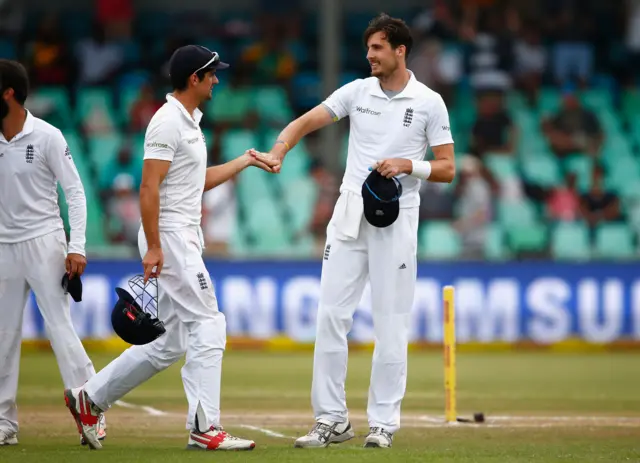 Steven Finn and Alastair Cook chat at the close of play