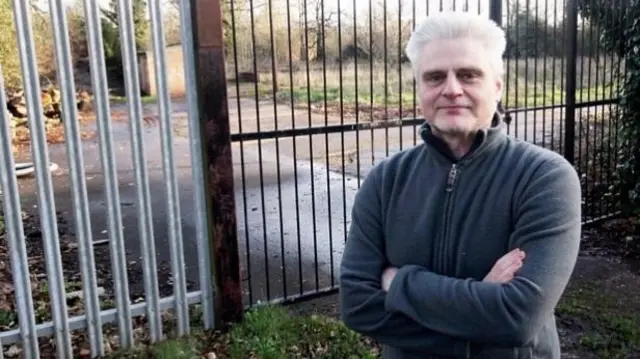 David Biggs stands in front of the proposed site