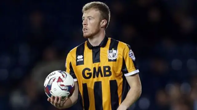 Sam Kelly in Port Vale shirt holding ball