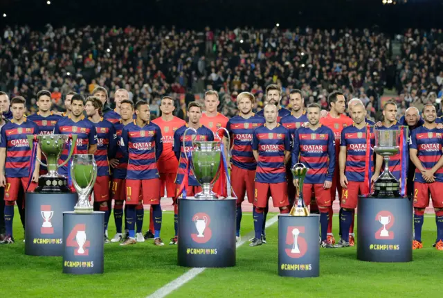 Barcelona players pose with trophies they've won