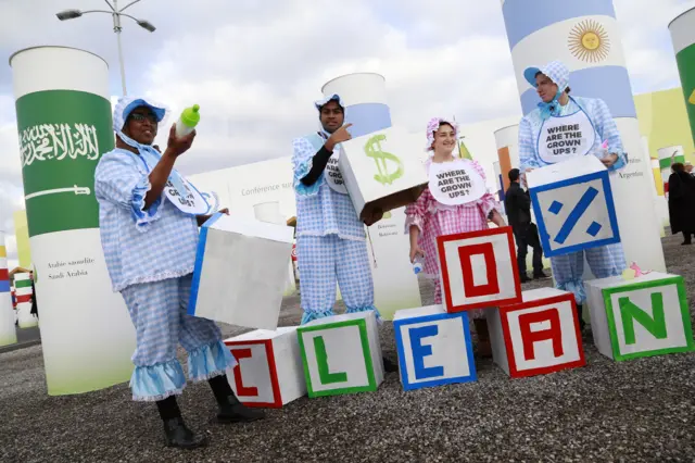 Protesters dressed as babies wielding giant building blocks