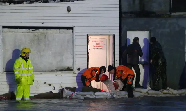 Men bail out water in the Ballybofey area of Donegal